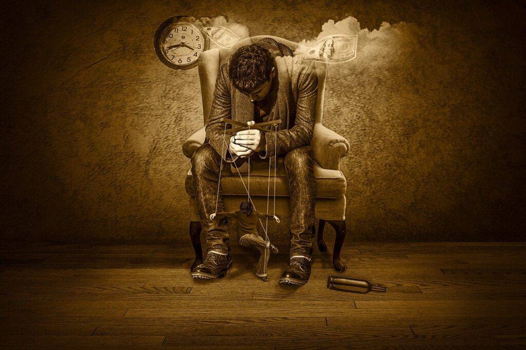 Man sitting in a chair being controlled by time.