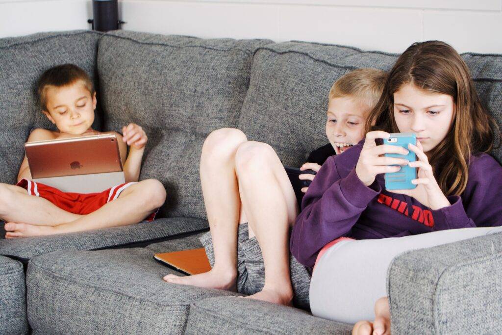 Innocent children tuning in on technological devices.