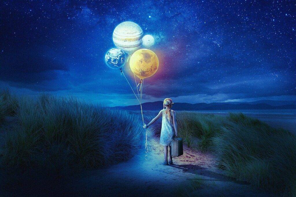 Girl holding balloons that are the planets of the solar system.