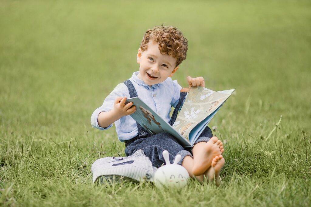 Little boy reading a book and full of dreams.